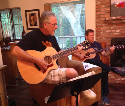 Members of the Acoustic Music Connection playing a song in the family room of a host member.